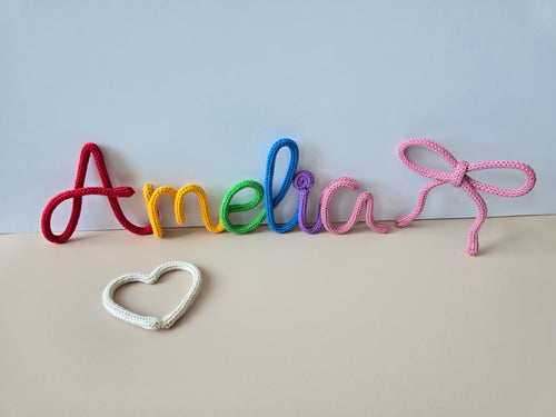 personalised knitted wire name Amelia with a heart and bow on a light background