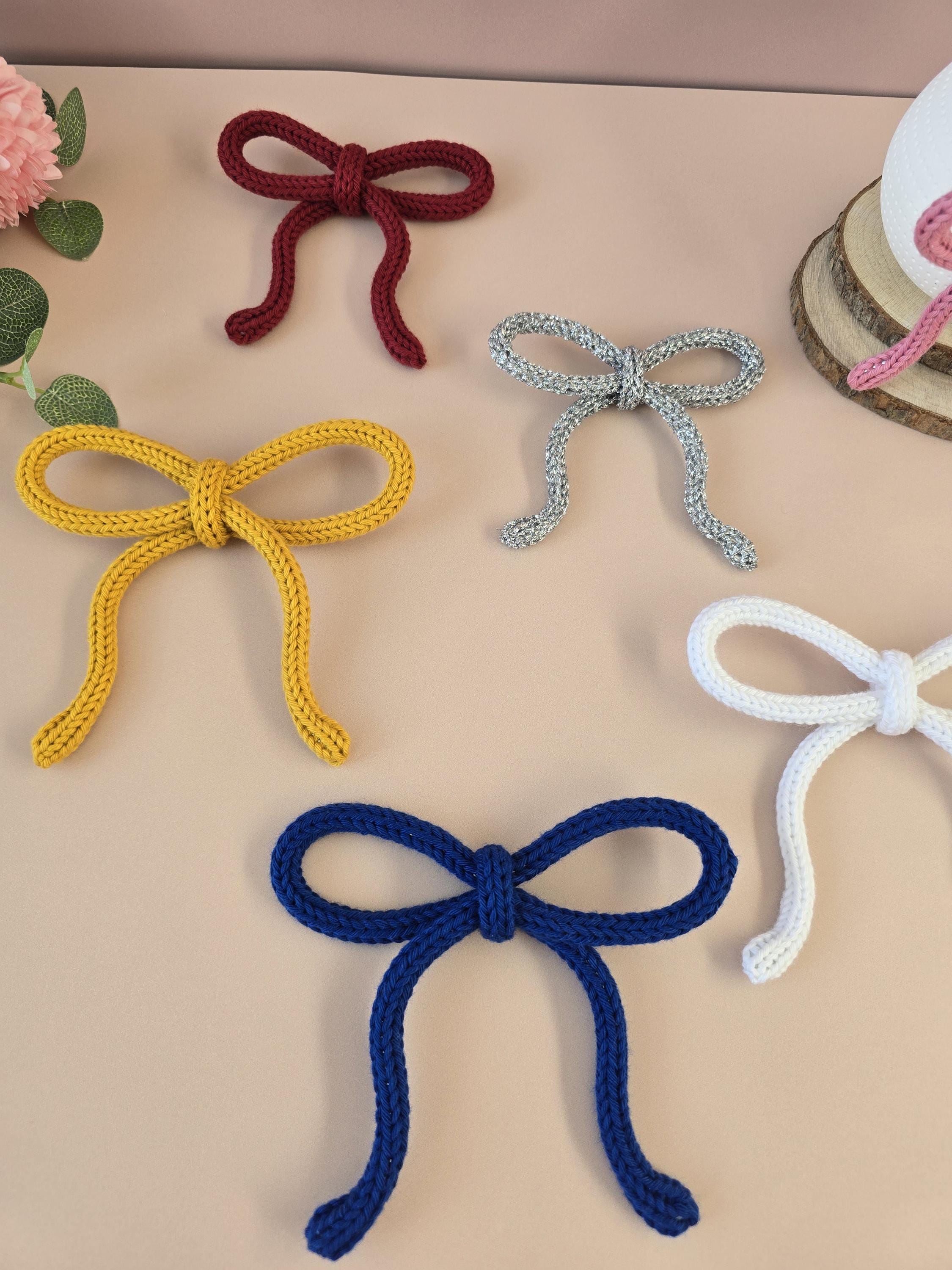 Large mustard knitted wire bow wall decor on neutral background