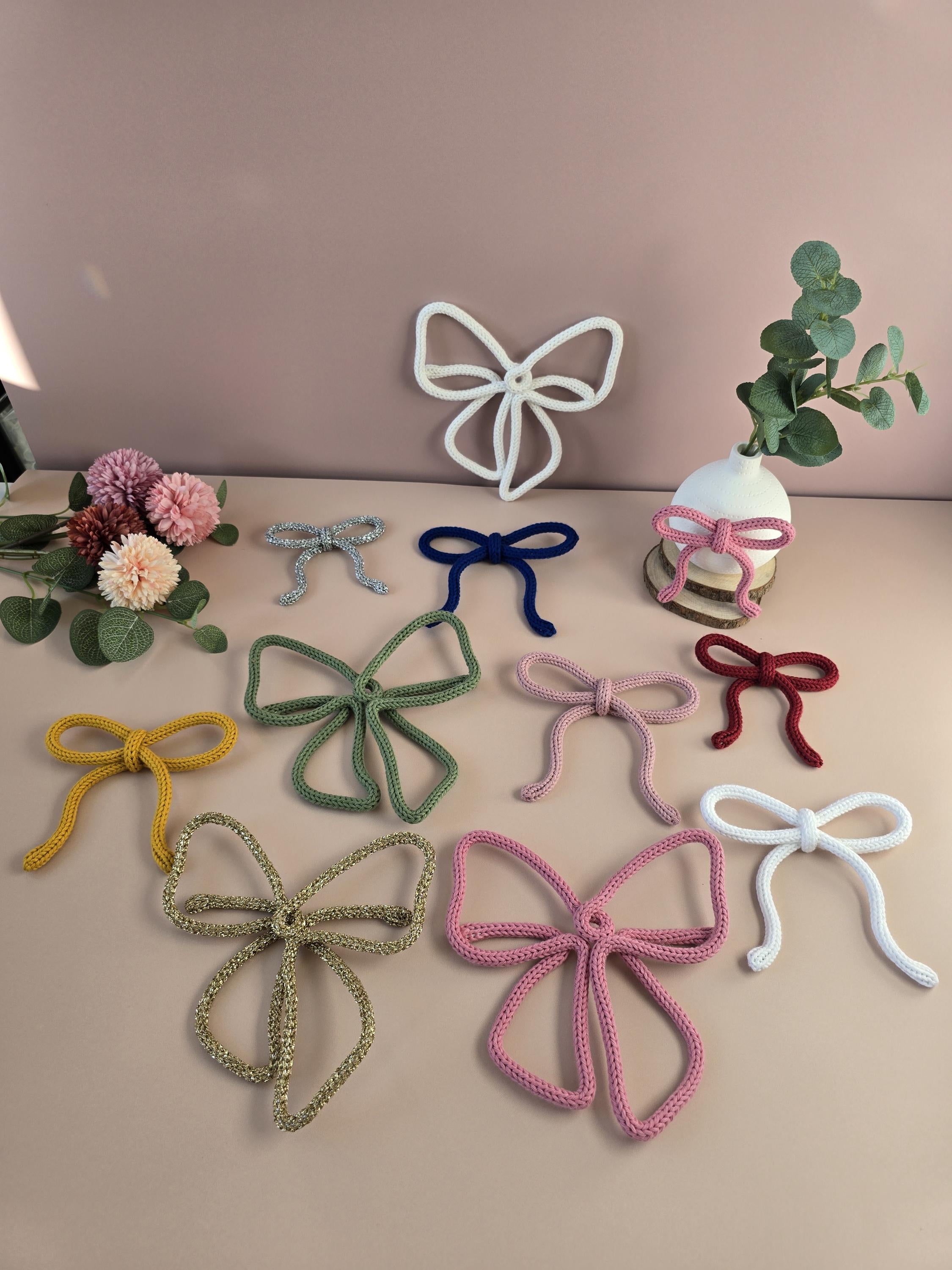White knitted wire bow decoration for nursery wall decor