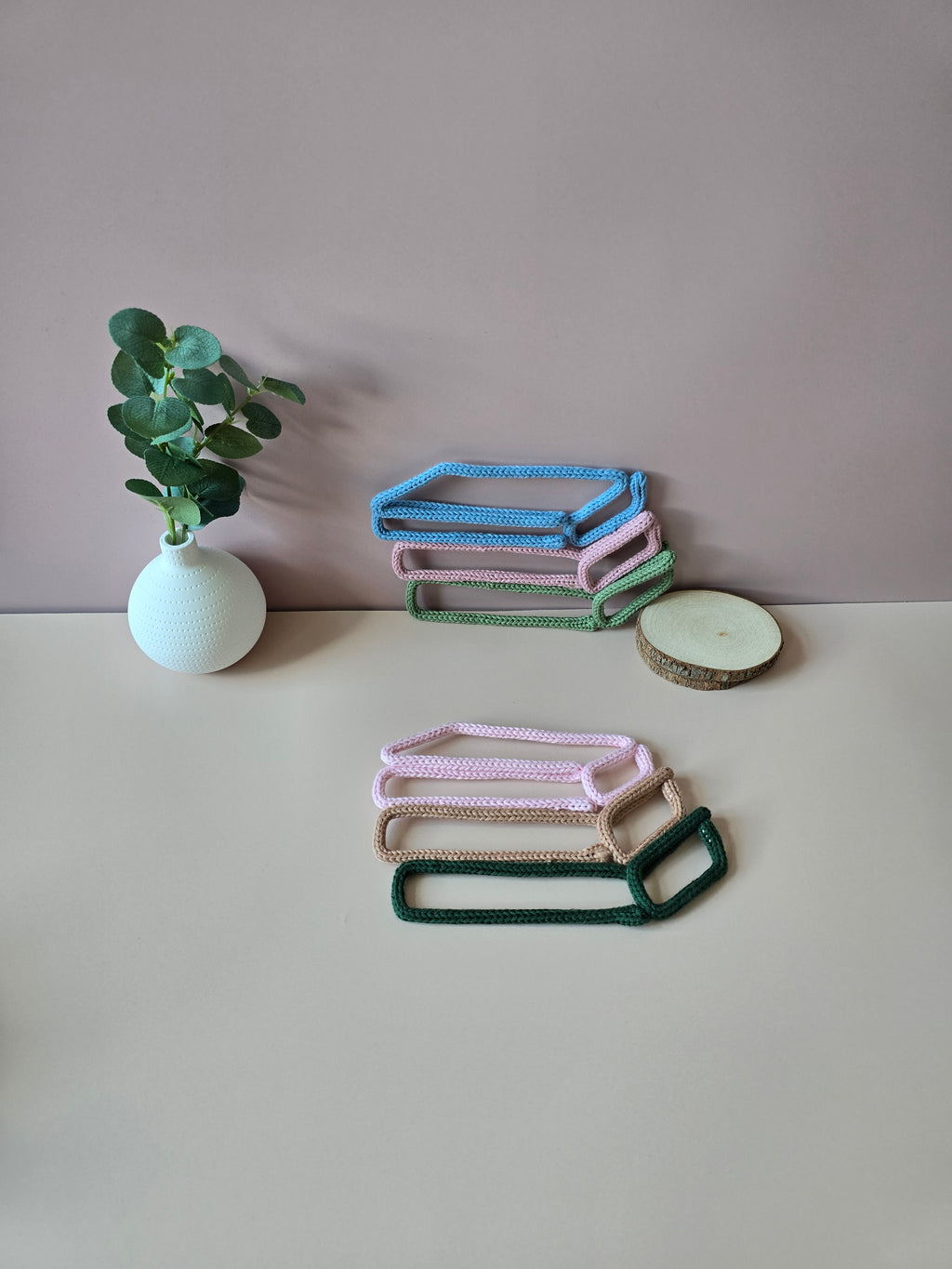 Knitted wire book stack wall decor in blue, pink and green