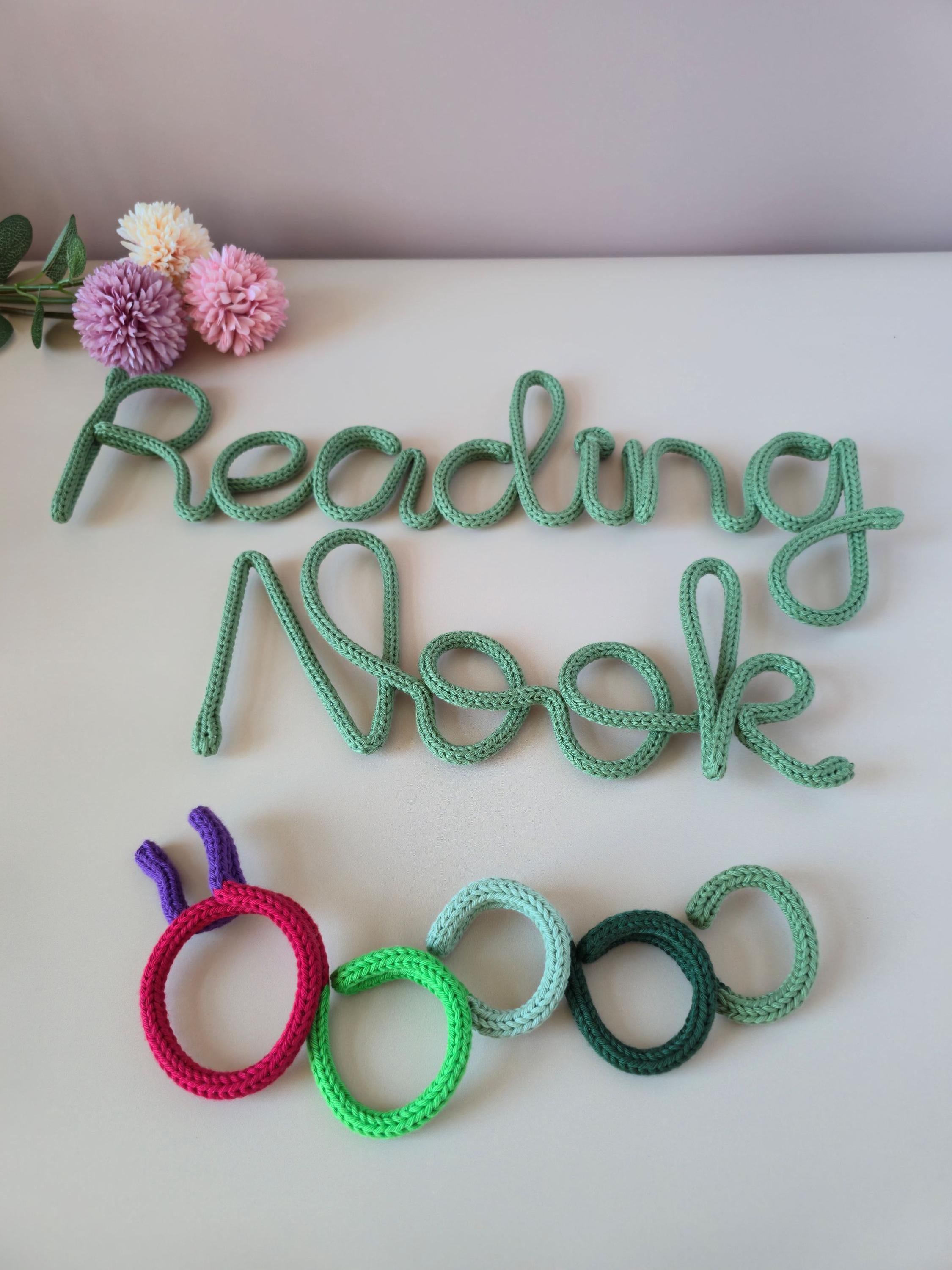 Bookworm wall decor displayed with Reading Nook knitted wire words