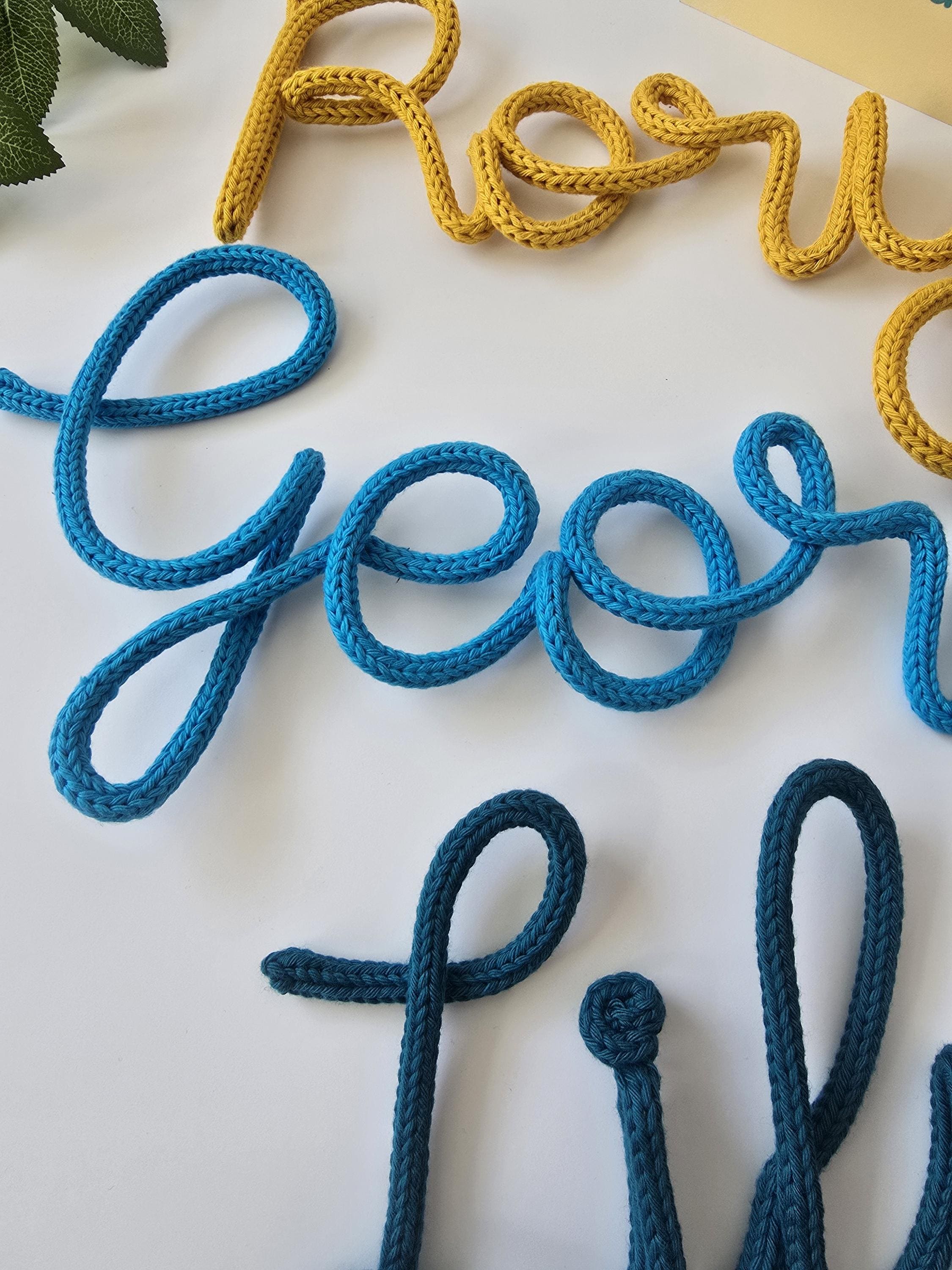 Colourful handmade knitted wire name signs for children’s rooms