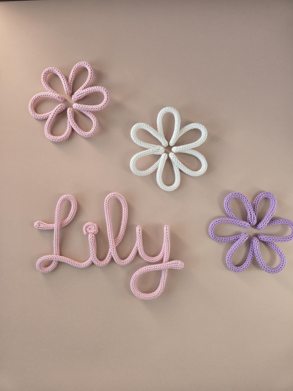 Knitted wire daisy flower decor styled with a personalised name sign