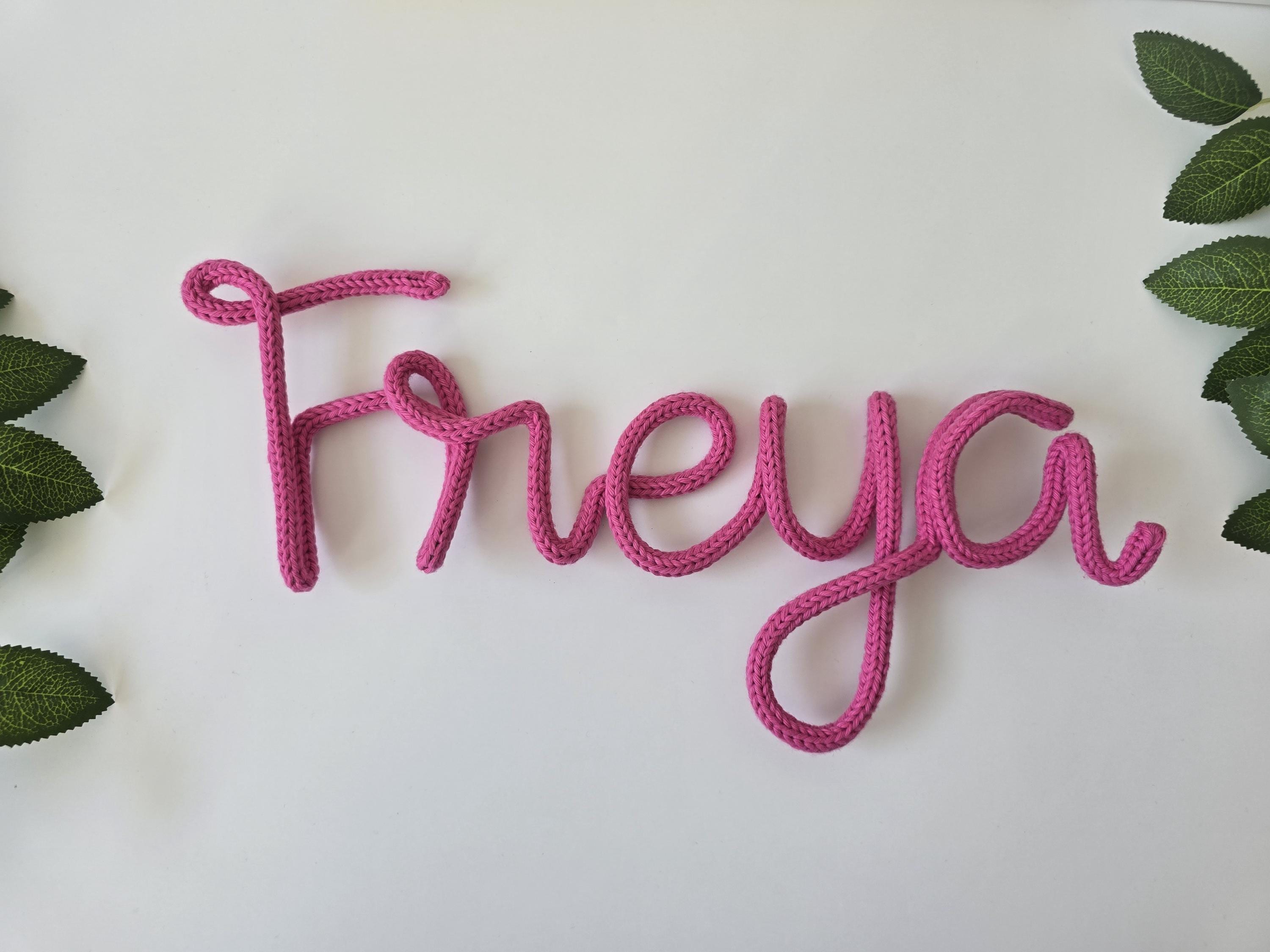 Pink personalised knitted wire name sign reading Freya