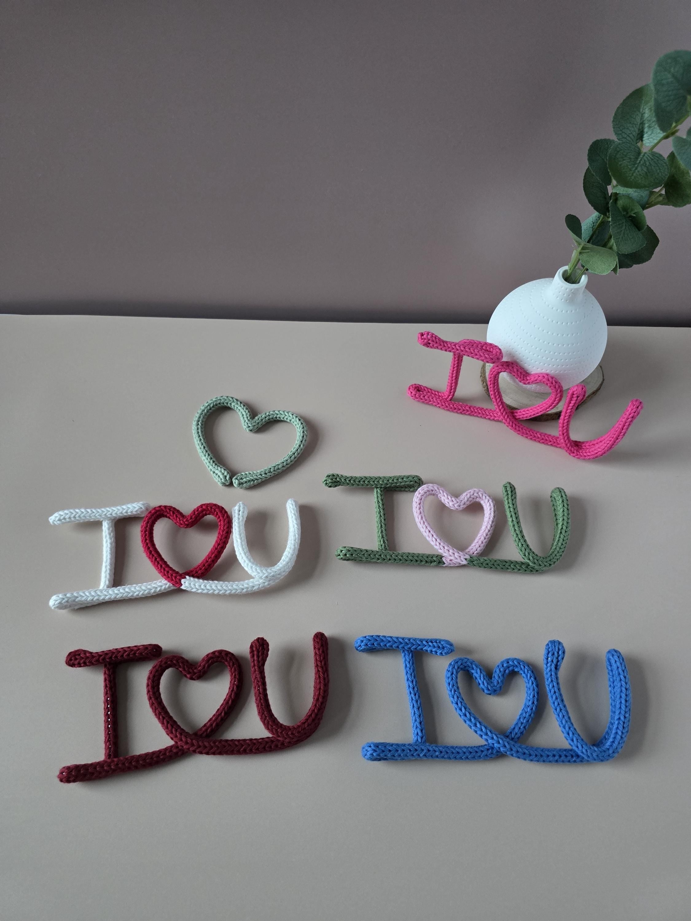 Knitted wire I Love You sign styled as romantic wall decor