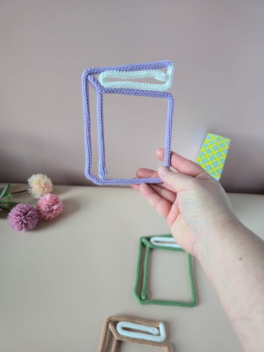 Knitted wire single book wall decor shown in different colour options