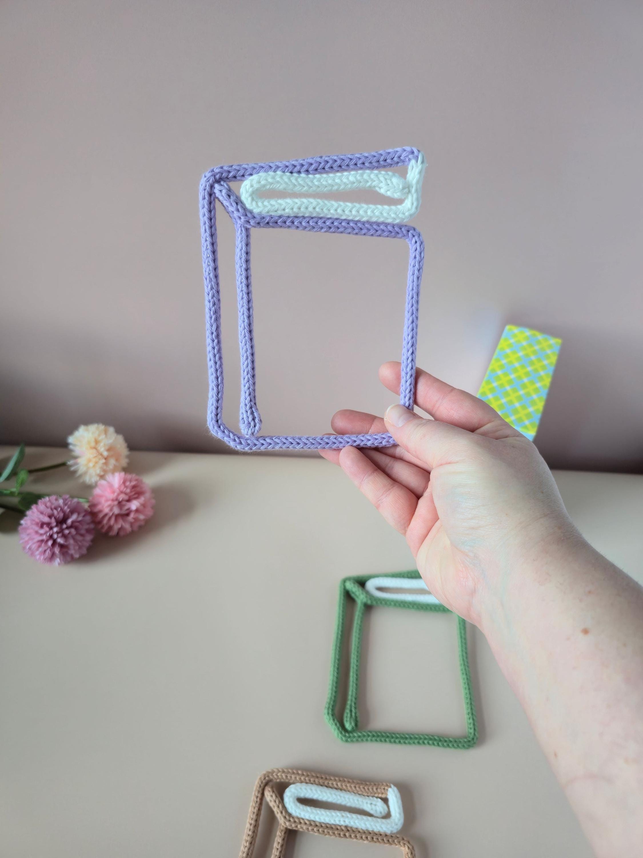 Knitted wire single book wall decor shown in different colour options
