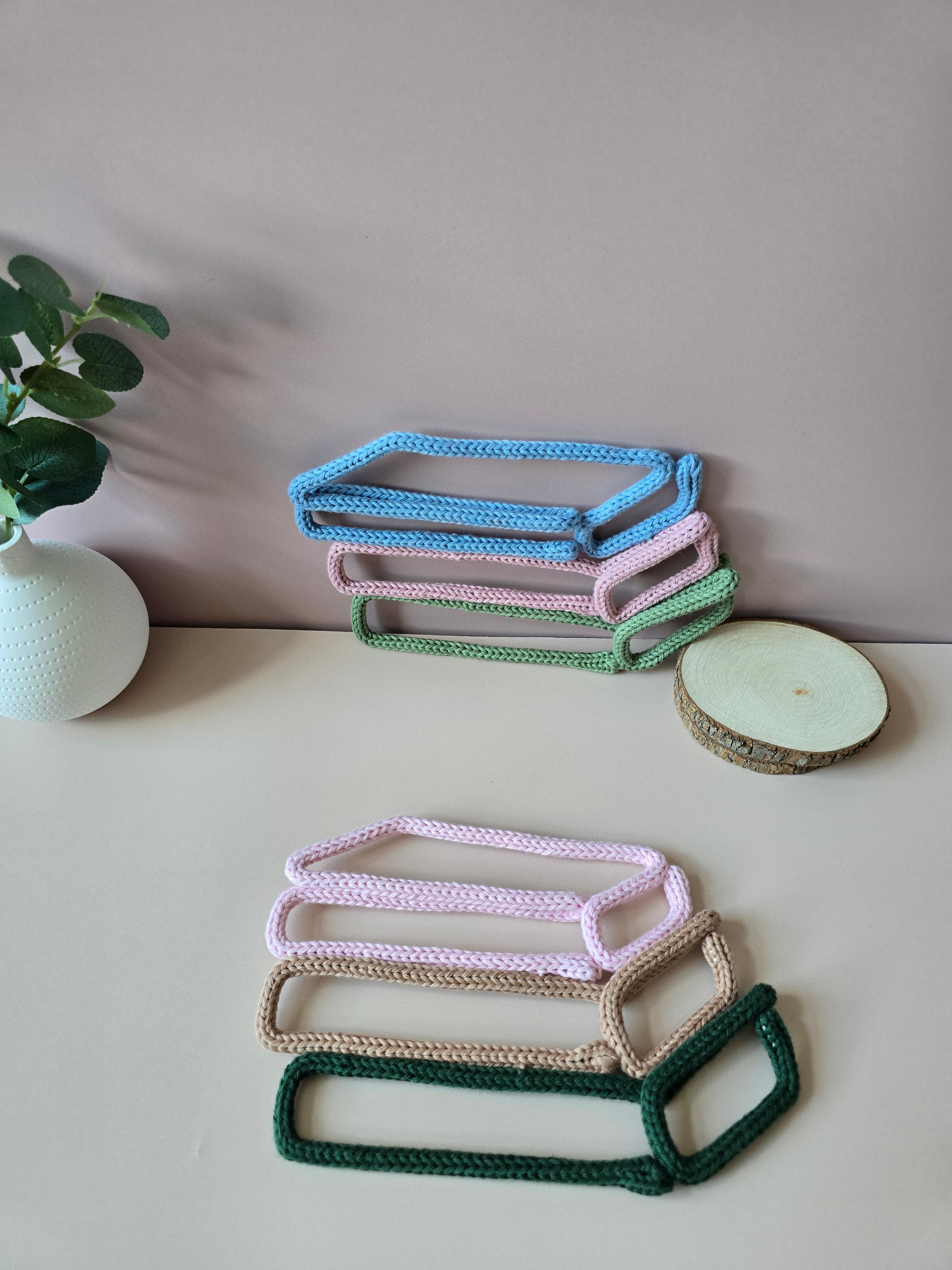 Close-up of handmade knitted wire book stack with cotton yarn texture