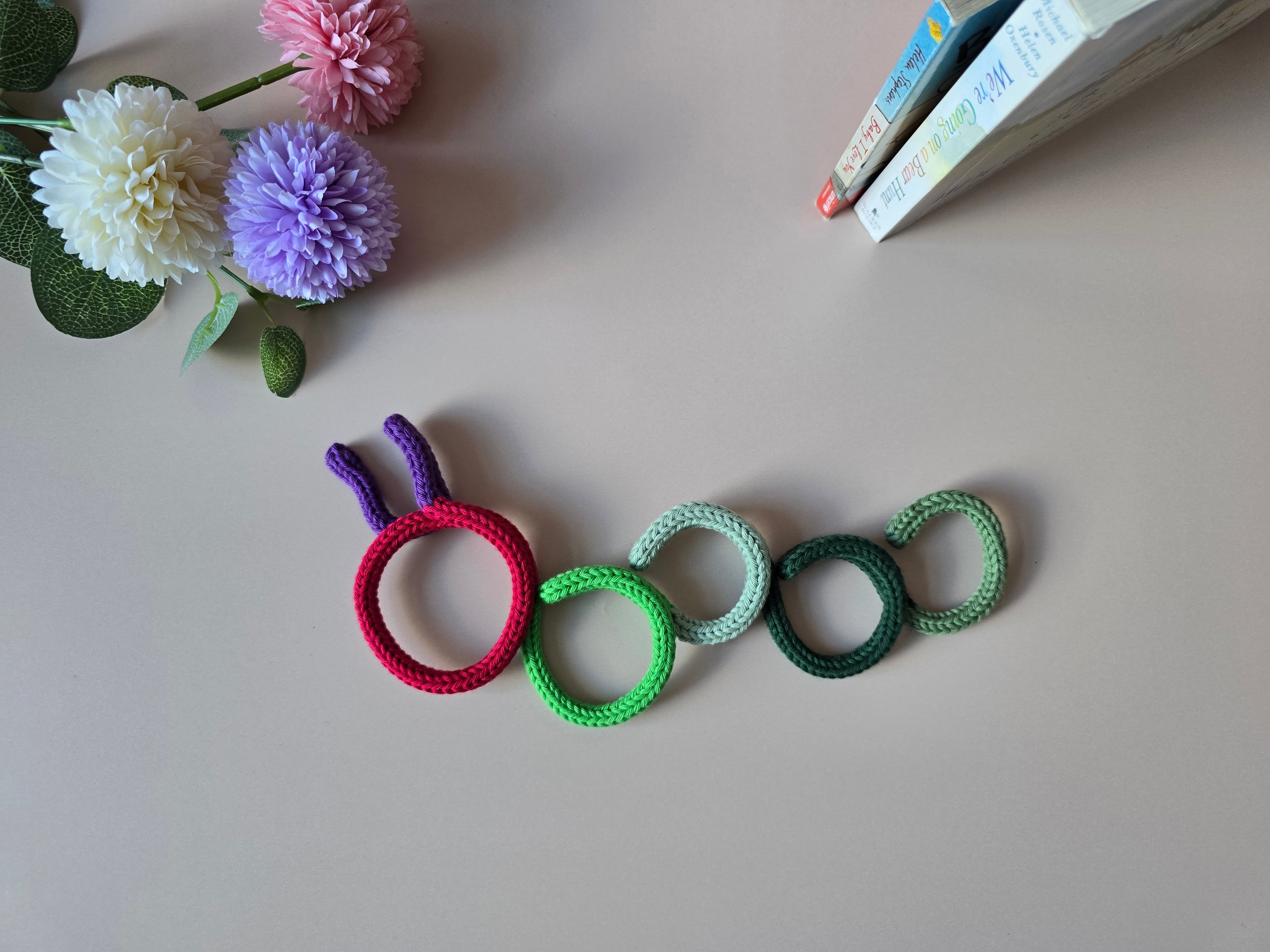 Handmade knitted wire bookworm wall decor for a reading corner