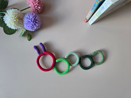 Handmade knitted wire bookworm wall decor for a reading corner