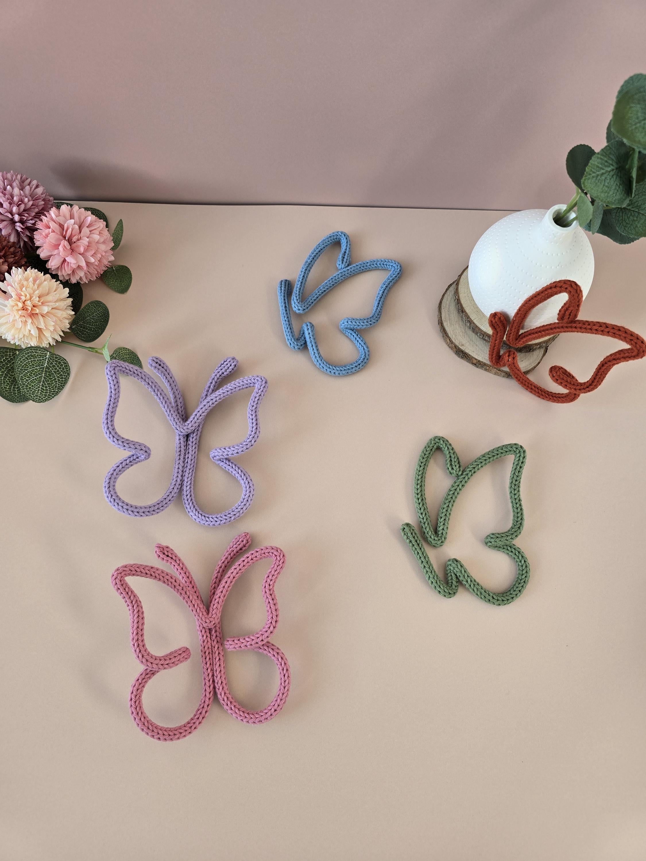 Knitted wire butterfly decorations shown in different colour options