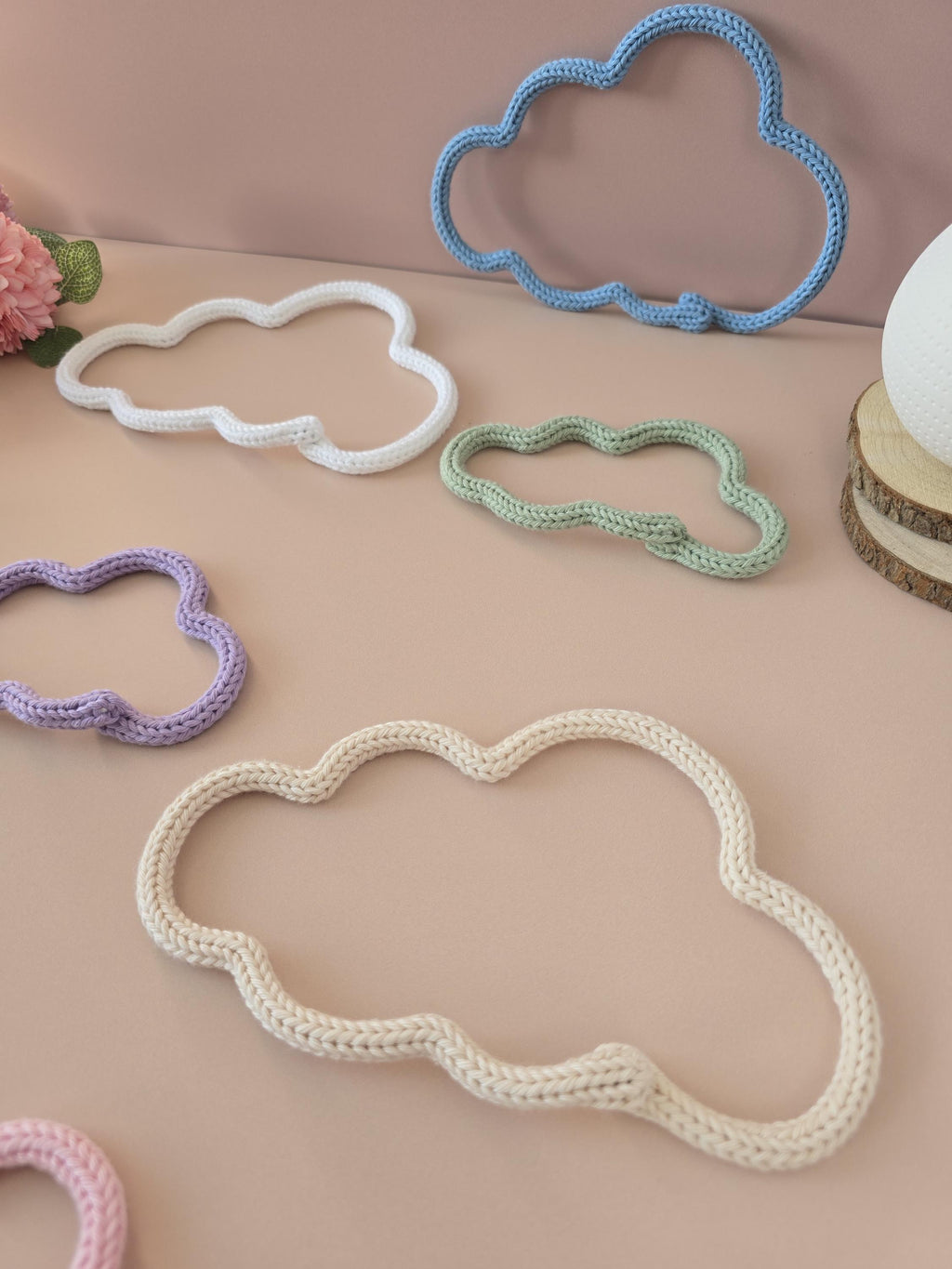 Close-up of knitted wire cloud wall decor with cotton yarn texture