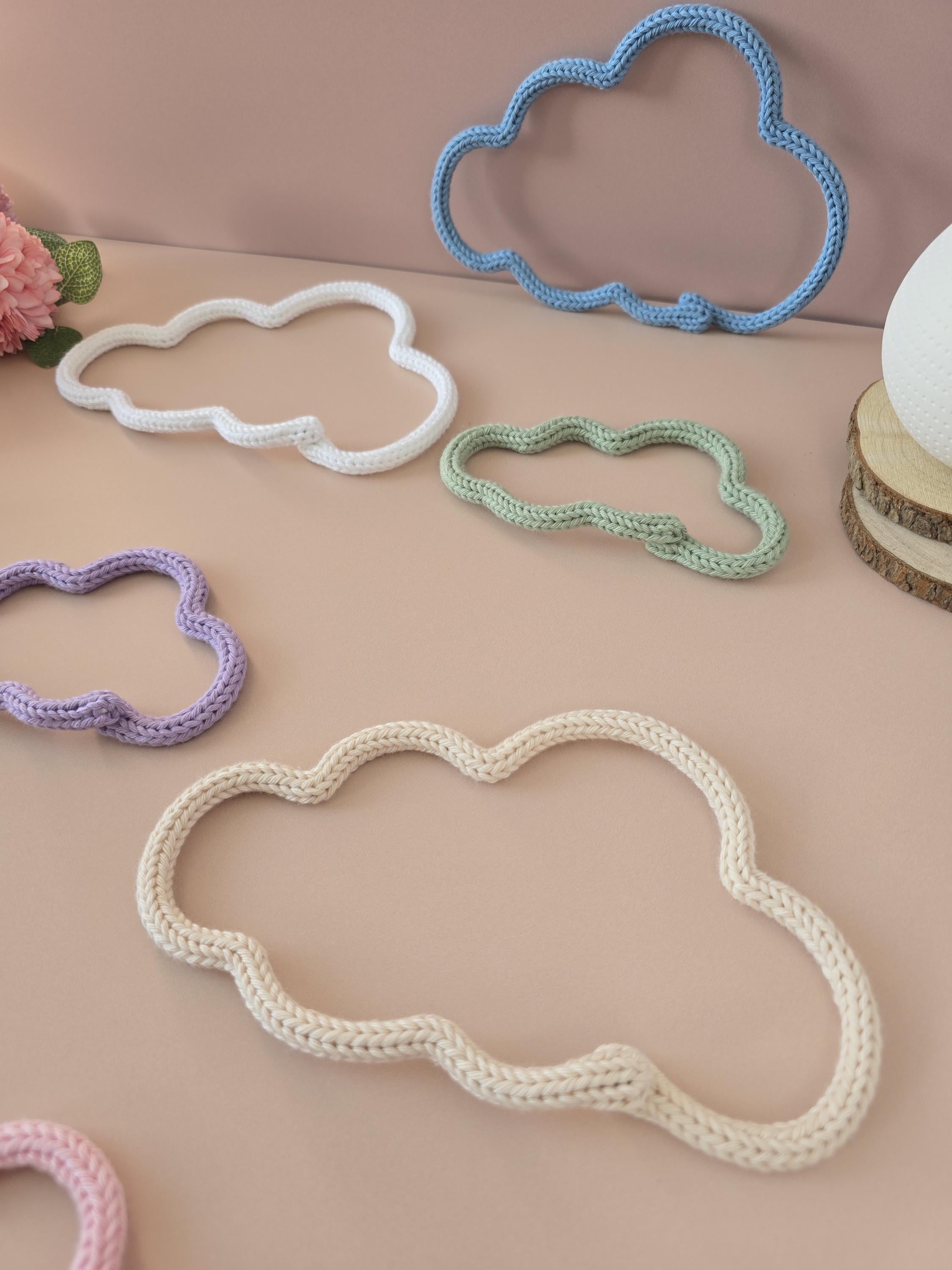 Close-up of knitted wire cloud wall decor with cotton yarn texture