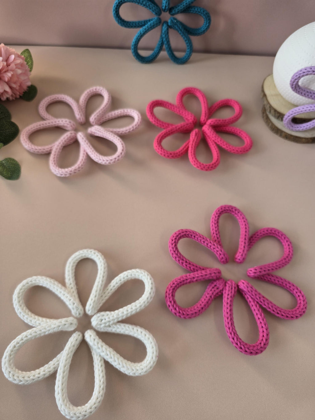 Close-up of handmade knitted wire daisy flower with cotton yarn texture