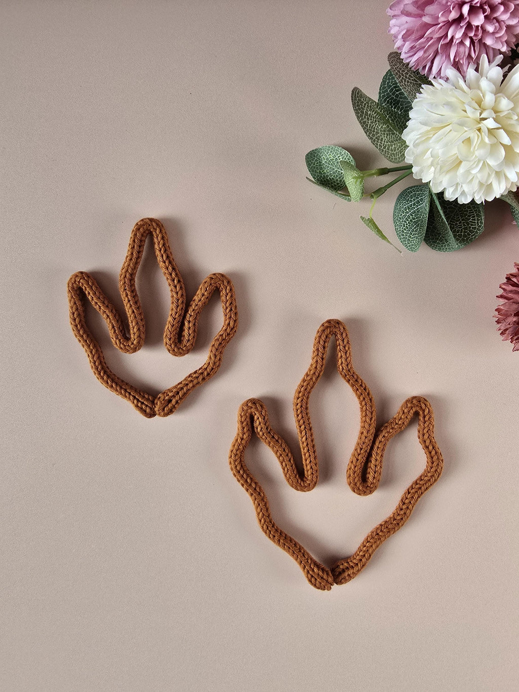 Handmade knitted wire dino paw wall decor in brown