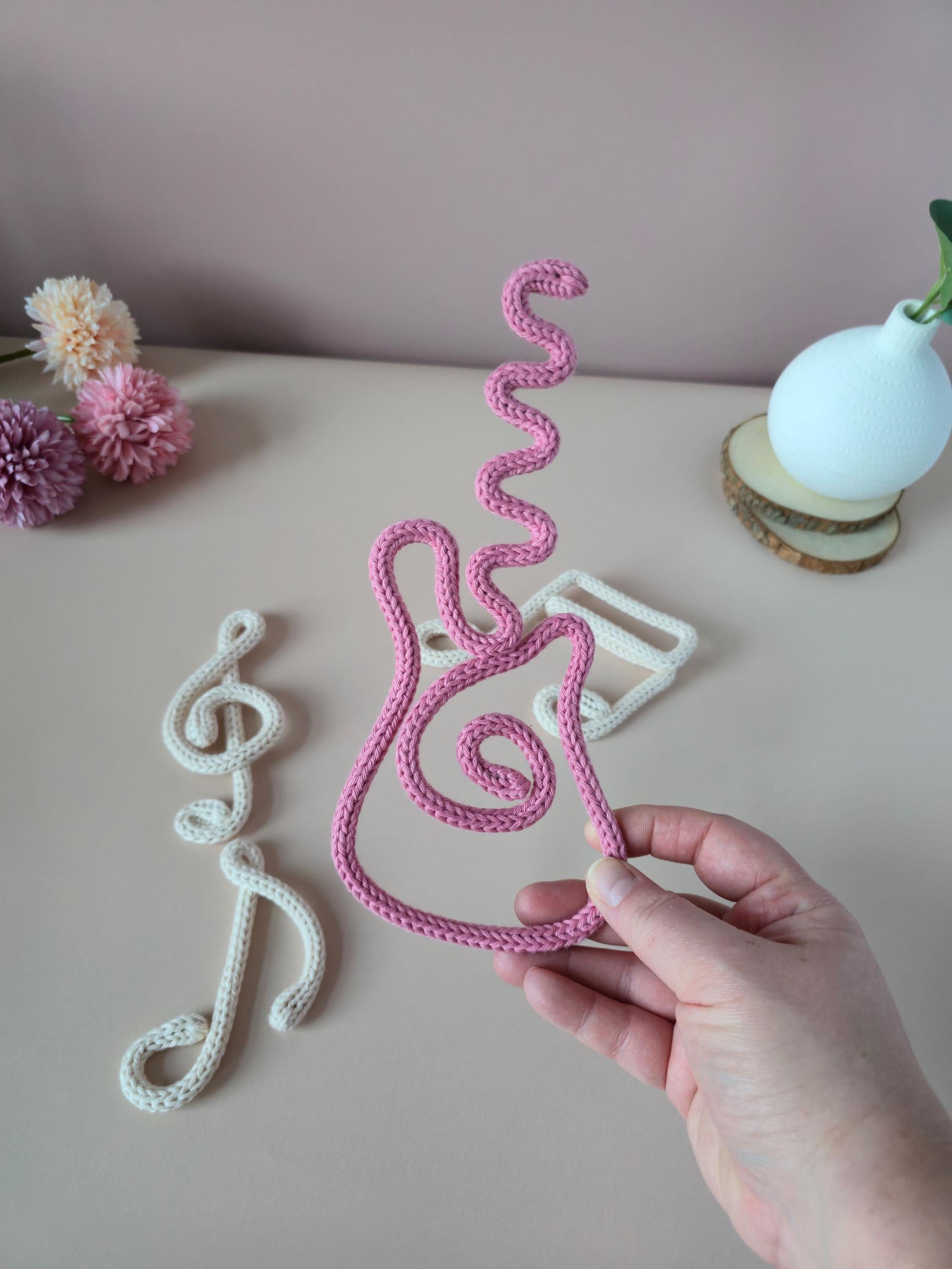 Handmade knitted wire guitar wall decor for music lovers, kids’ bedrooms, nurseries and playrooms.