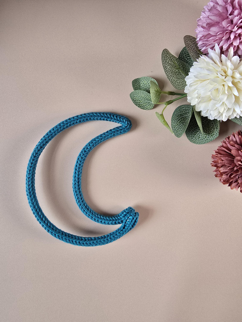 Handmade knitted wire moon wall decor in blue