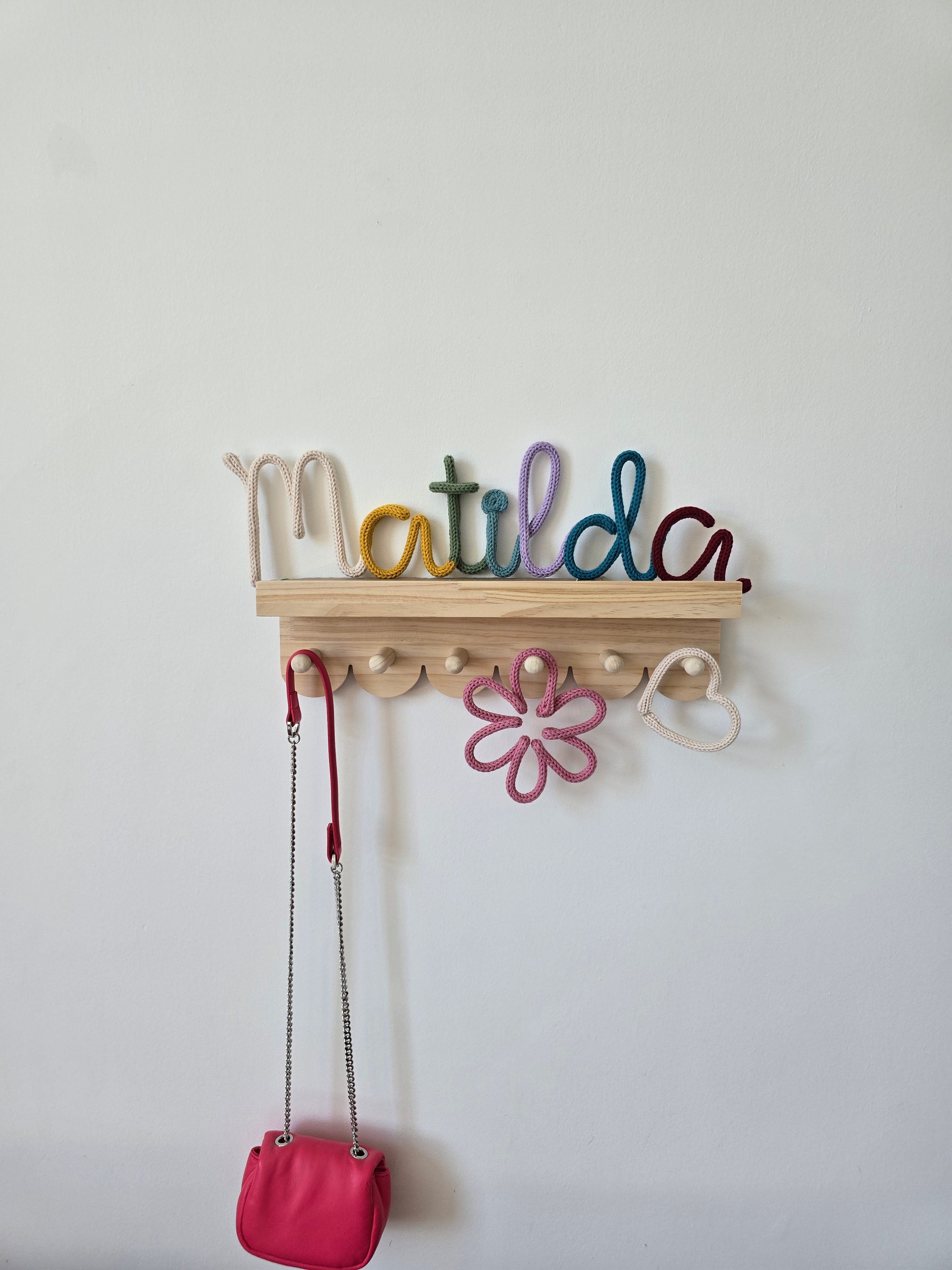 CraftyBabs multicoloured knitted wire name sign with a small heart detail, handmade for nurseries and children’s bedrooms.