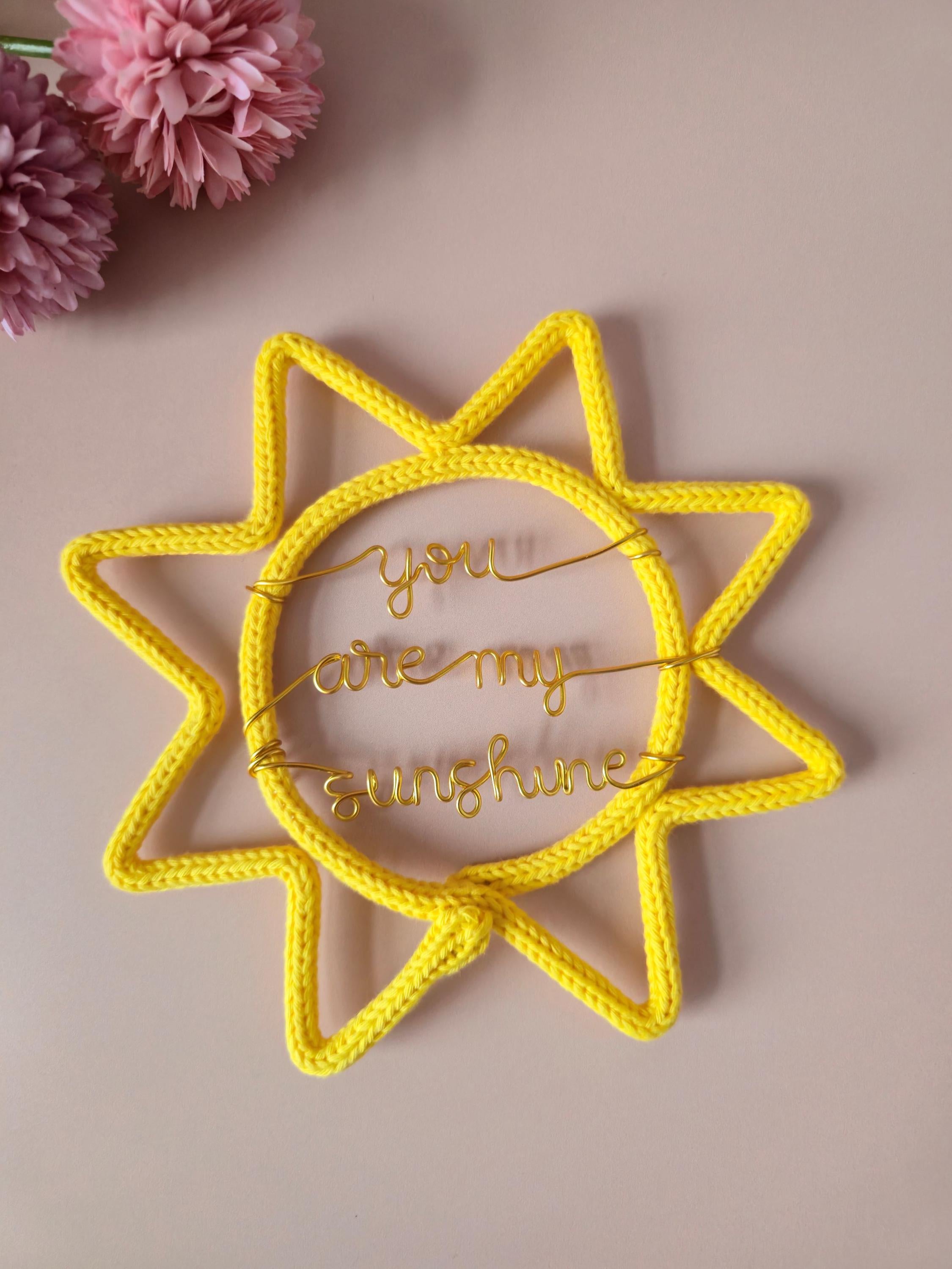 Handmade knitted wire You Are My Sunshine sign in yellow for nursery wall decor