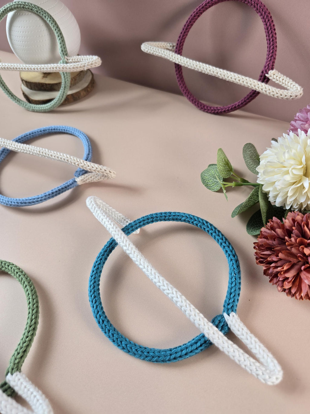 Knitted wire planet decorations shown in several colour combinations