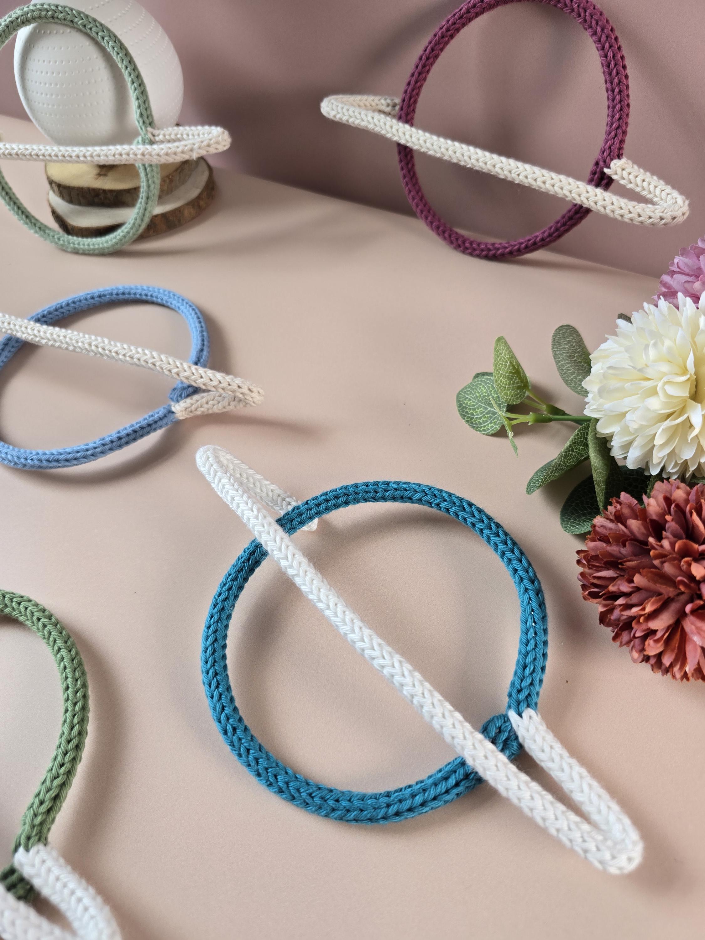 Knitted wire planet decorations shown in several colour combinations