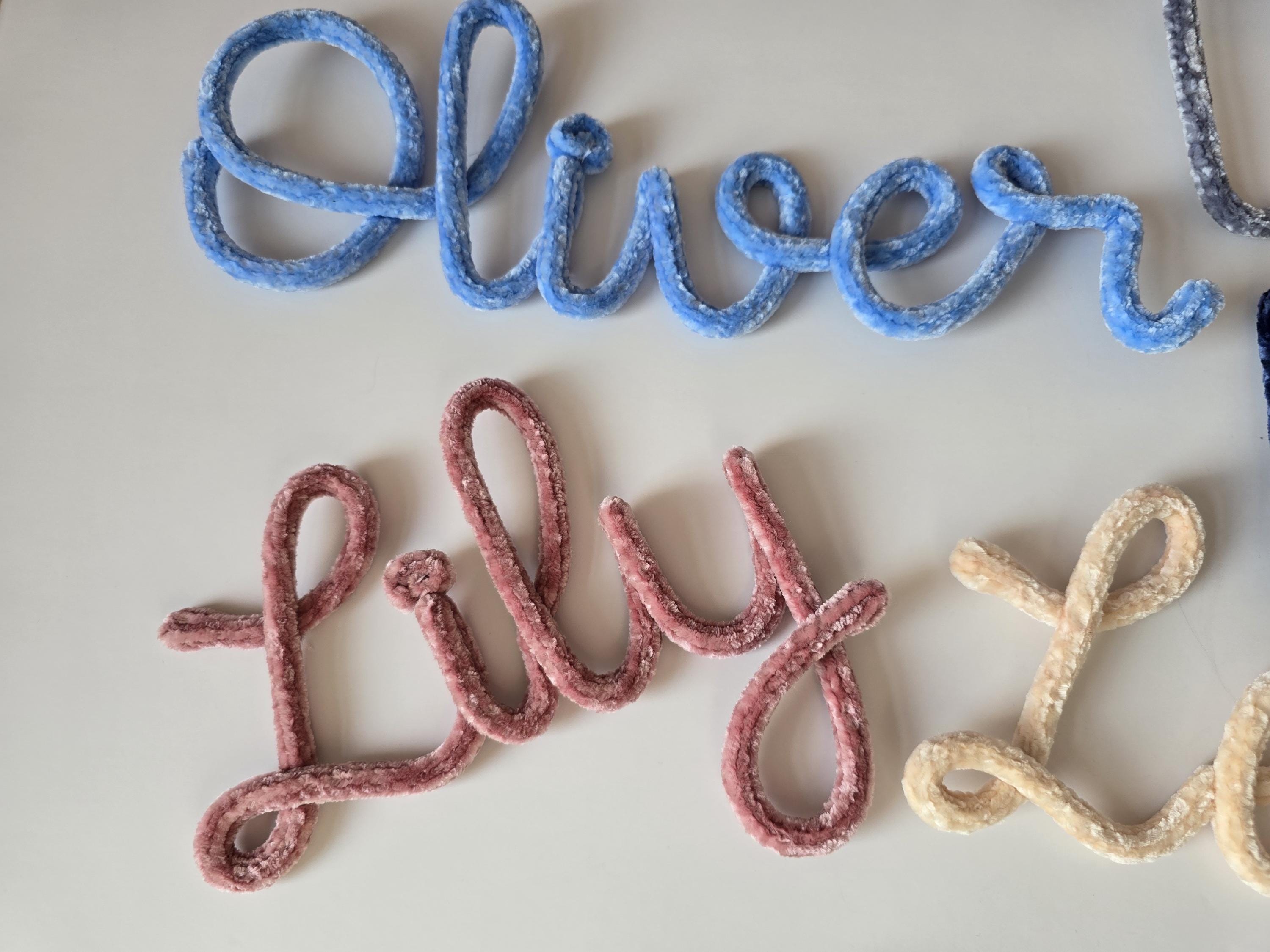 Blue velvet knitted wire name sign reading Oliver