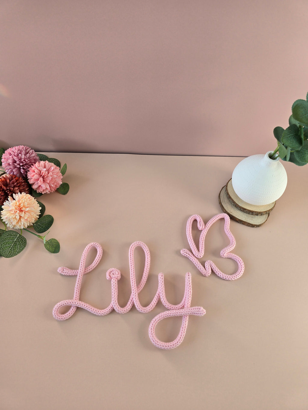 Decorative pink knitted personalised name with matching butterfly