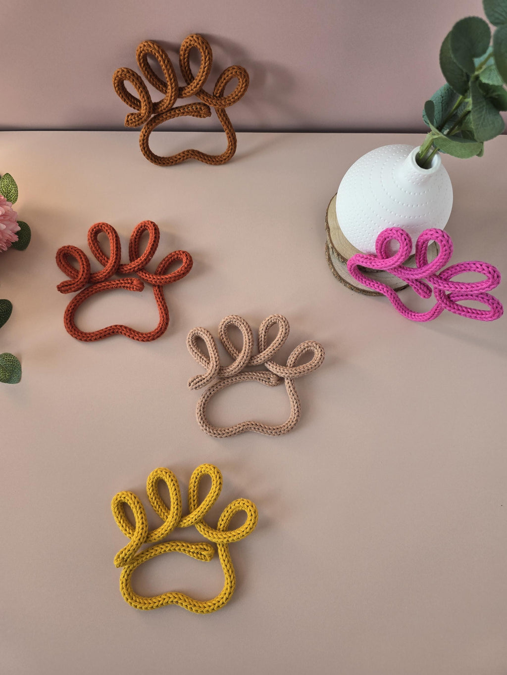 Pink knitted wire dog paw decor styled with flowers
