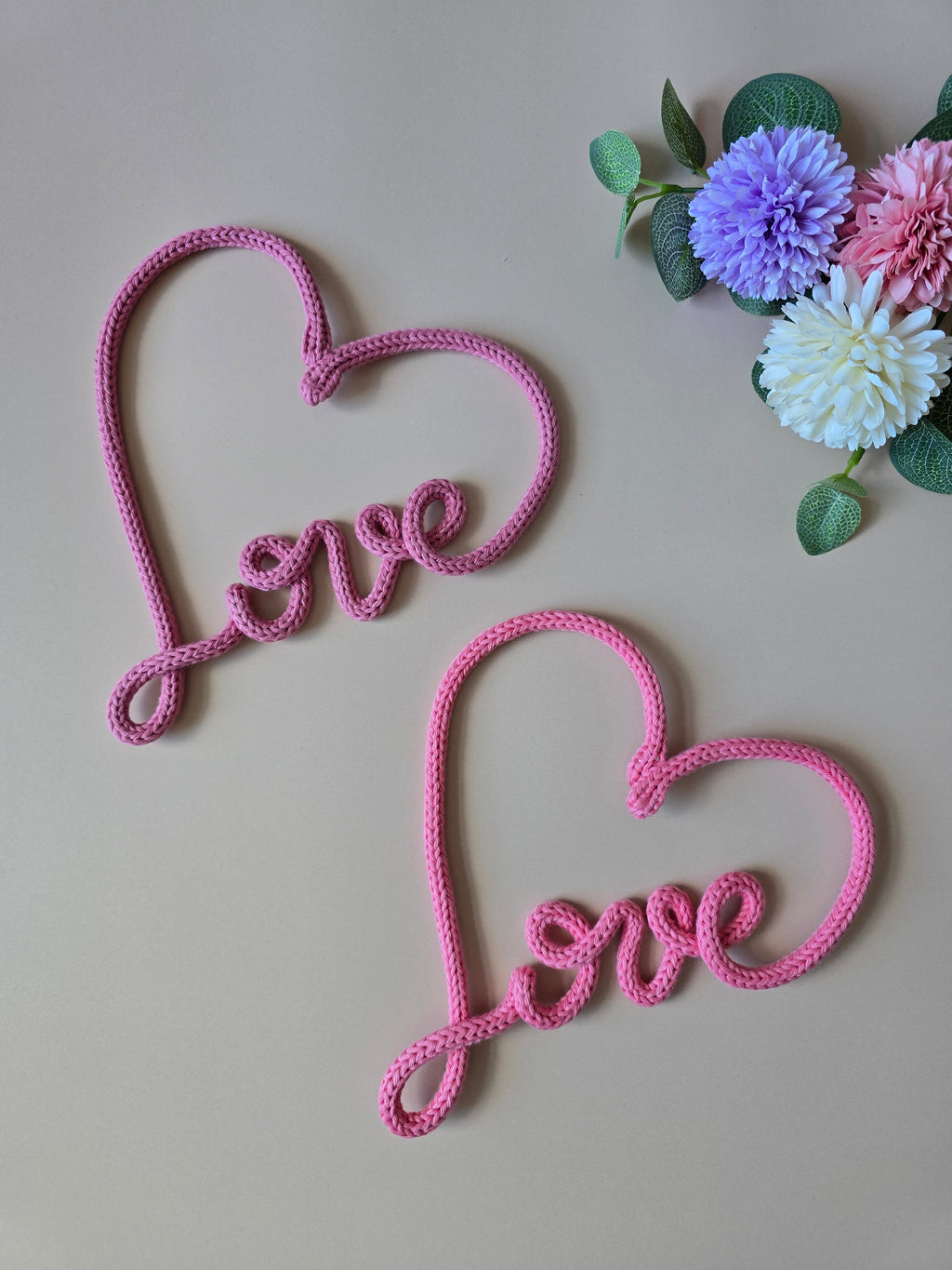 Pink knitted wire love heart sign with flowers