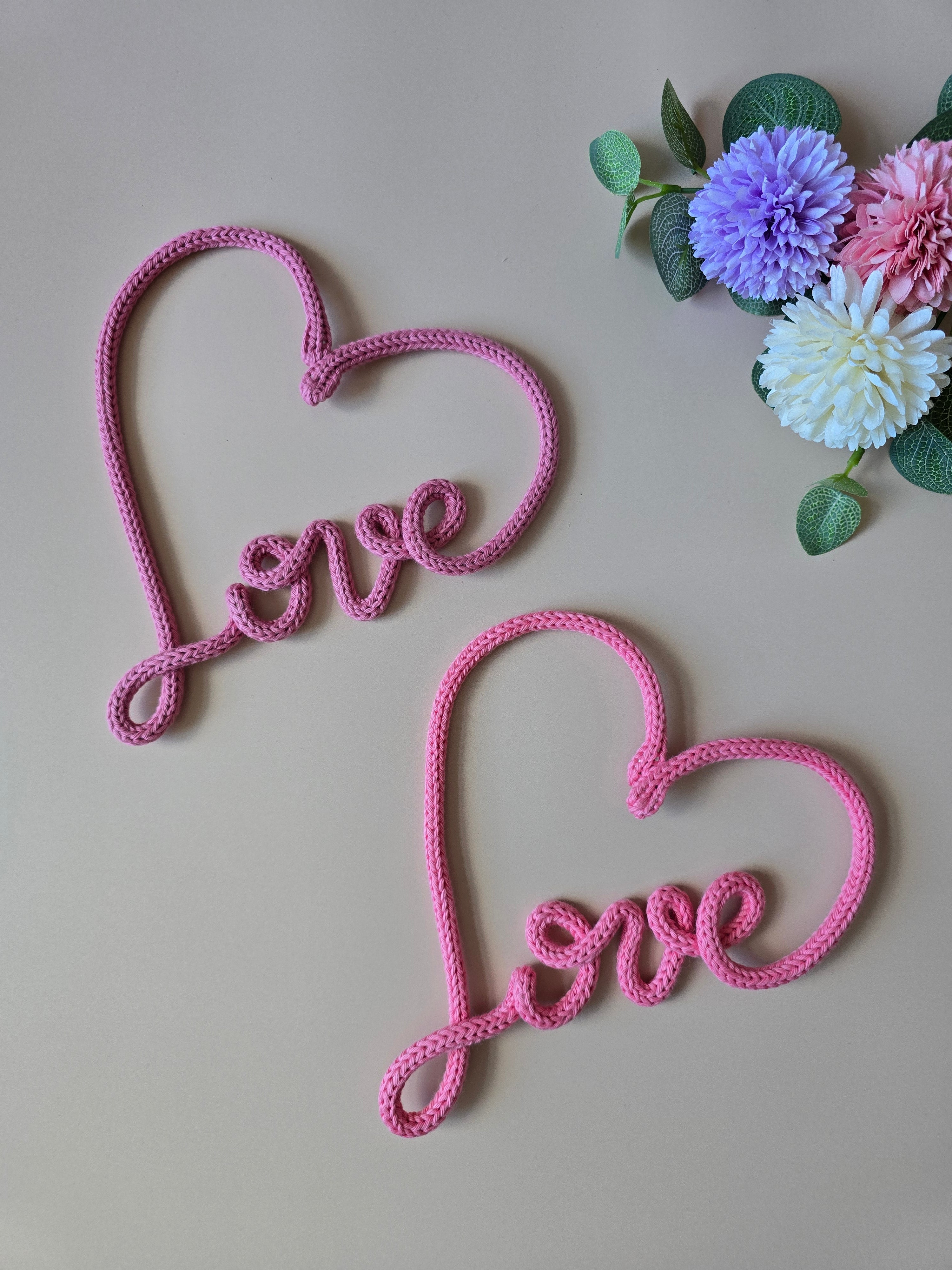 Pink knitted wire love heart sign with flowers