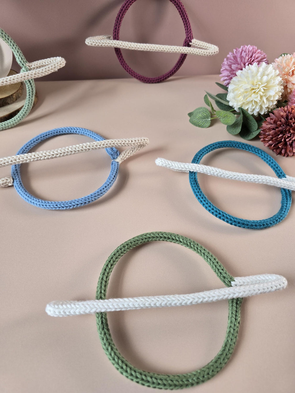 Knitted wire planet decorations shown in several colour combinations