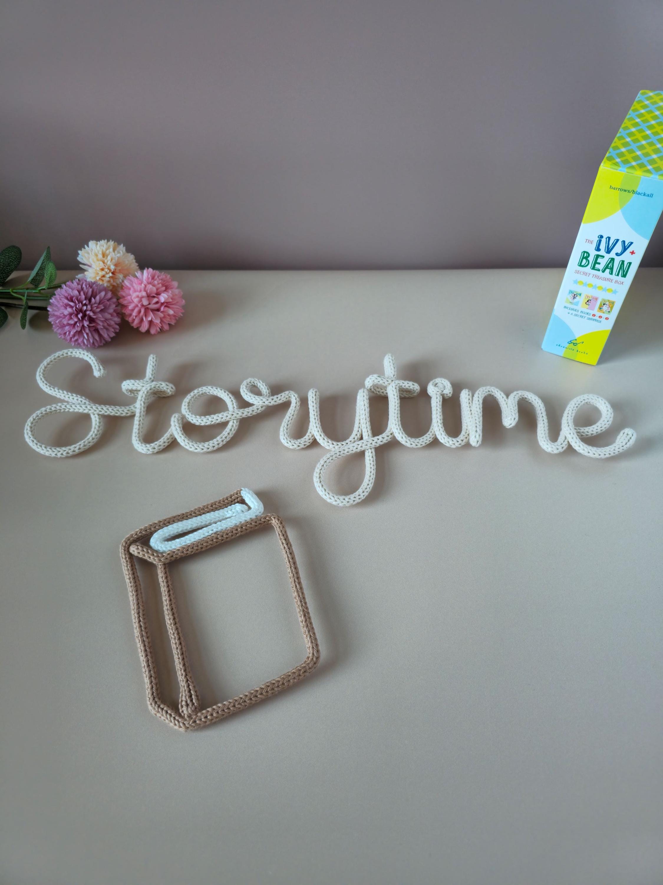 Reading corner decor with knitted wire book stack and wall words