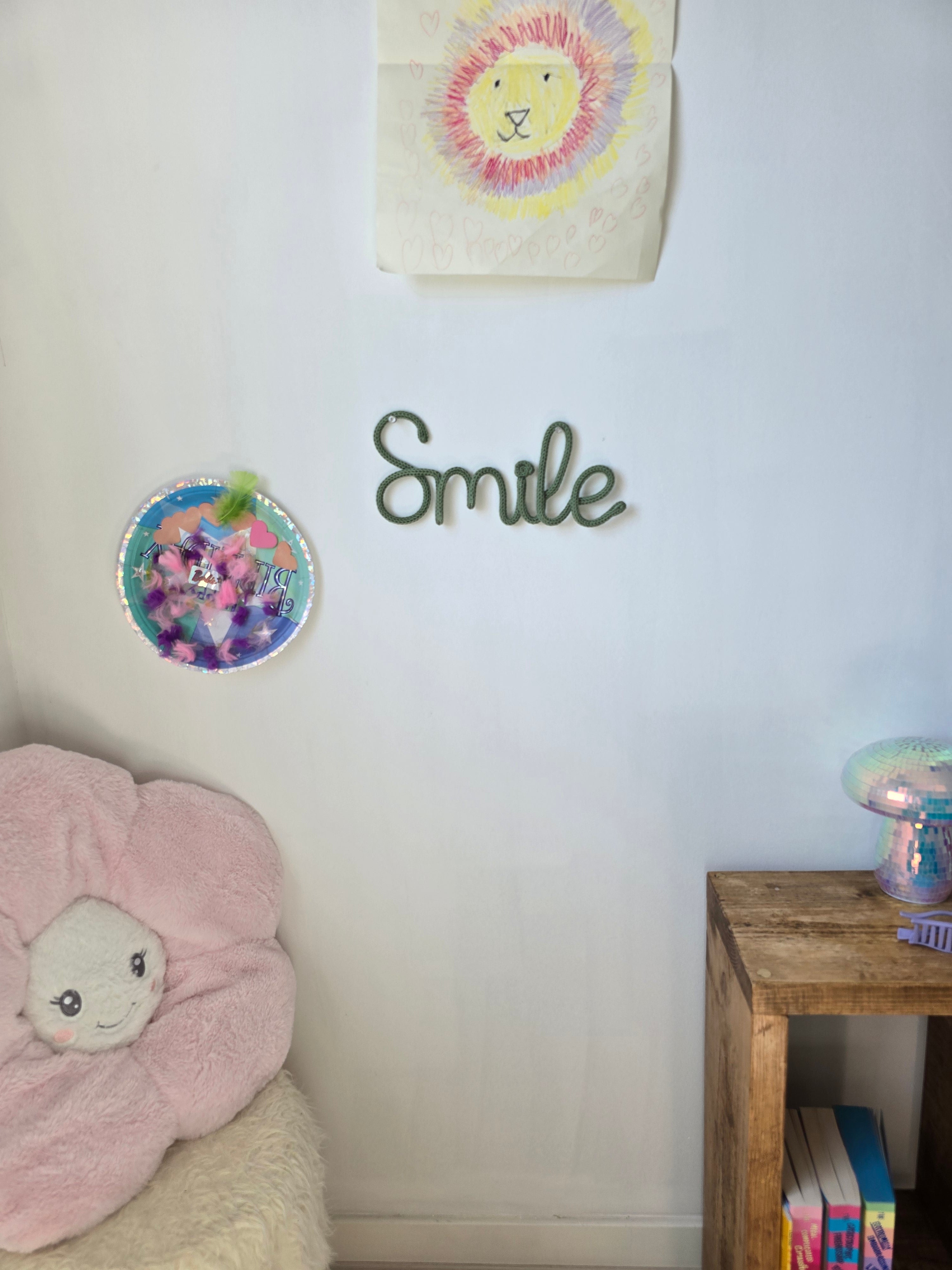 Smile knitted wire sign displayed in a child's bedroom