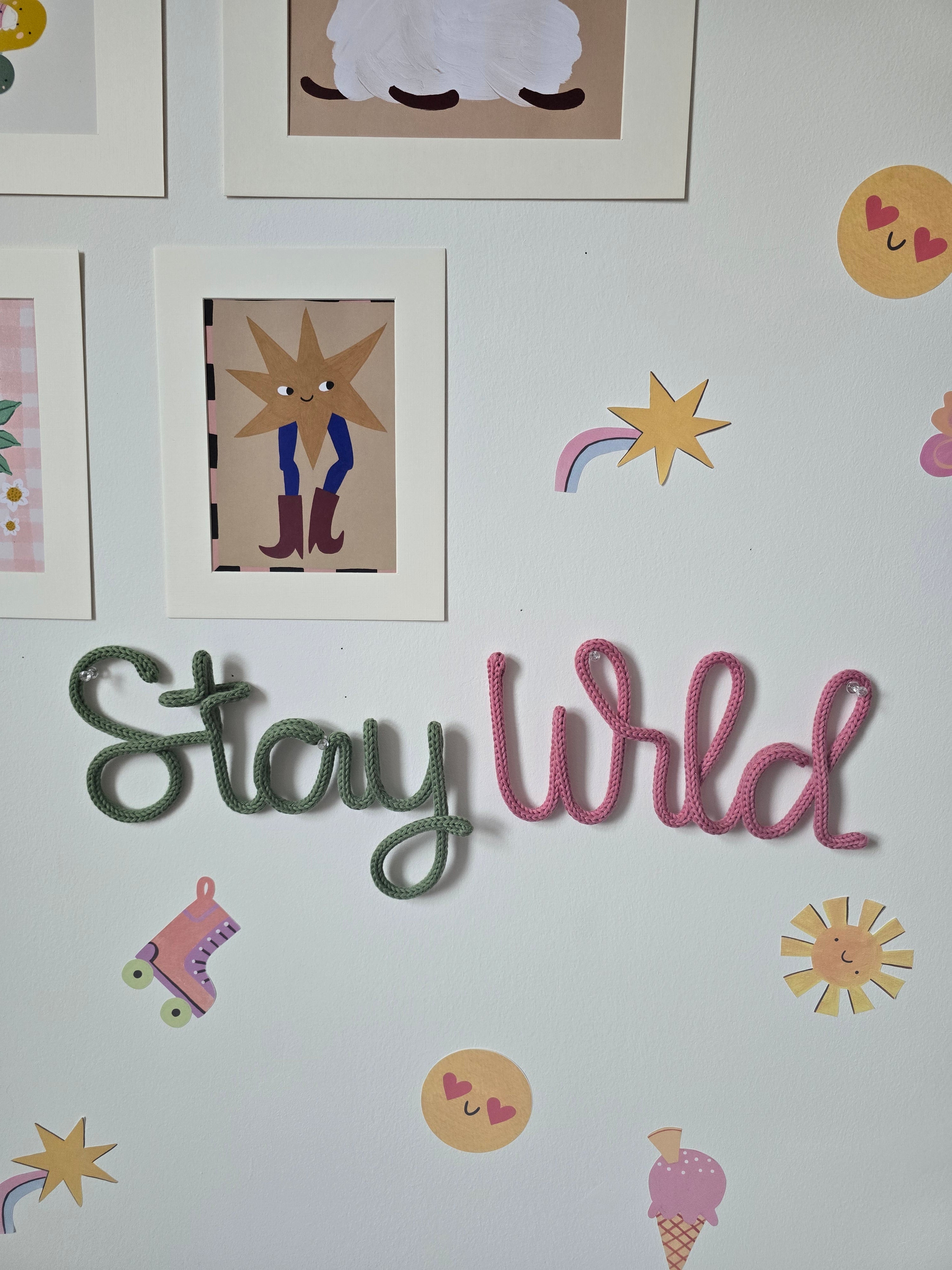 Close-up of handmade knitted wire Stay Wild sign