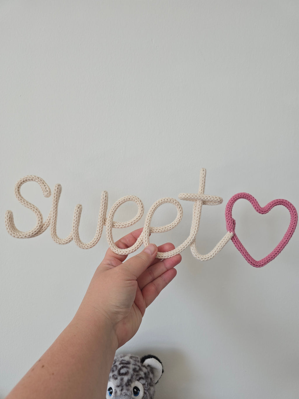 Close-up of handmade sweetheart knitted wire sign
