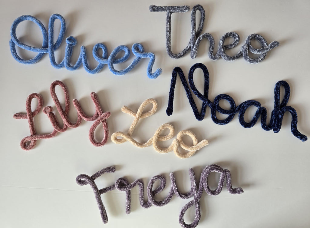 Velvet knitted wire name sign reading Leo styled on a shelf